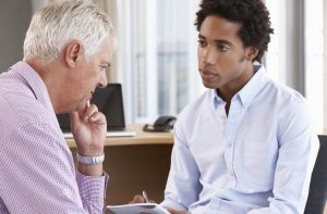 man speaking with a social worker