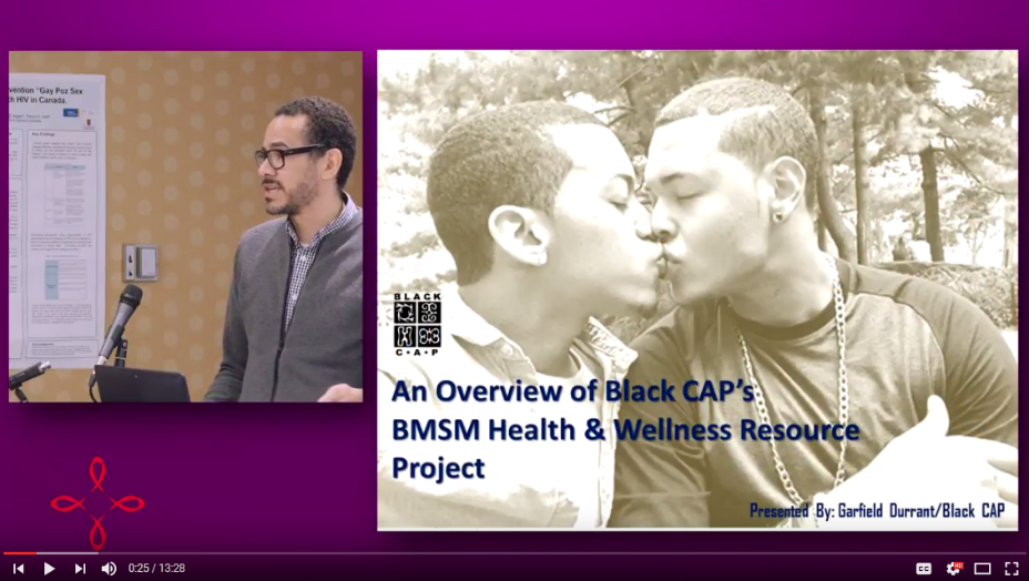 Presentor Garfield Durrant talking about the BMSM project next to an image of two Black men kissing