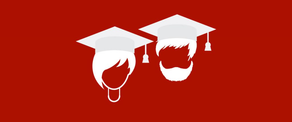 Two people wear graduation caps.