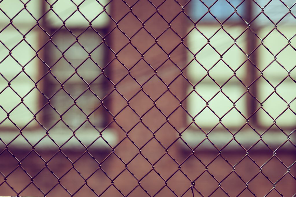 Looking at a building through a chain link fence