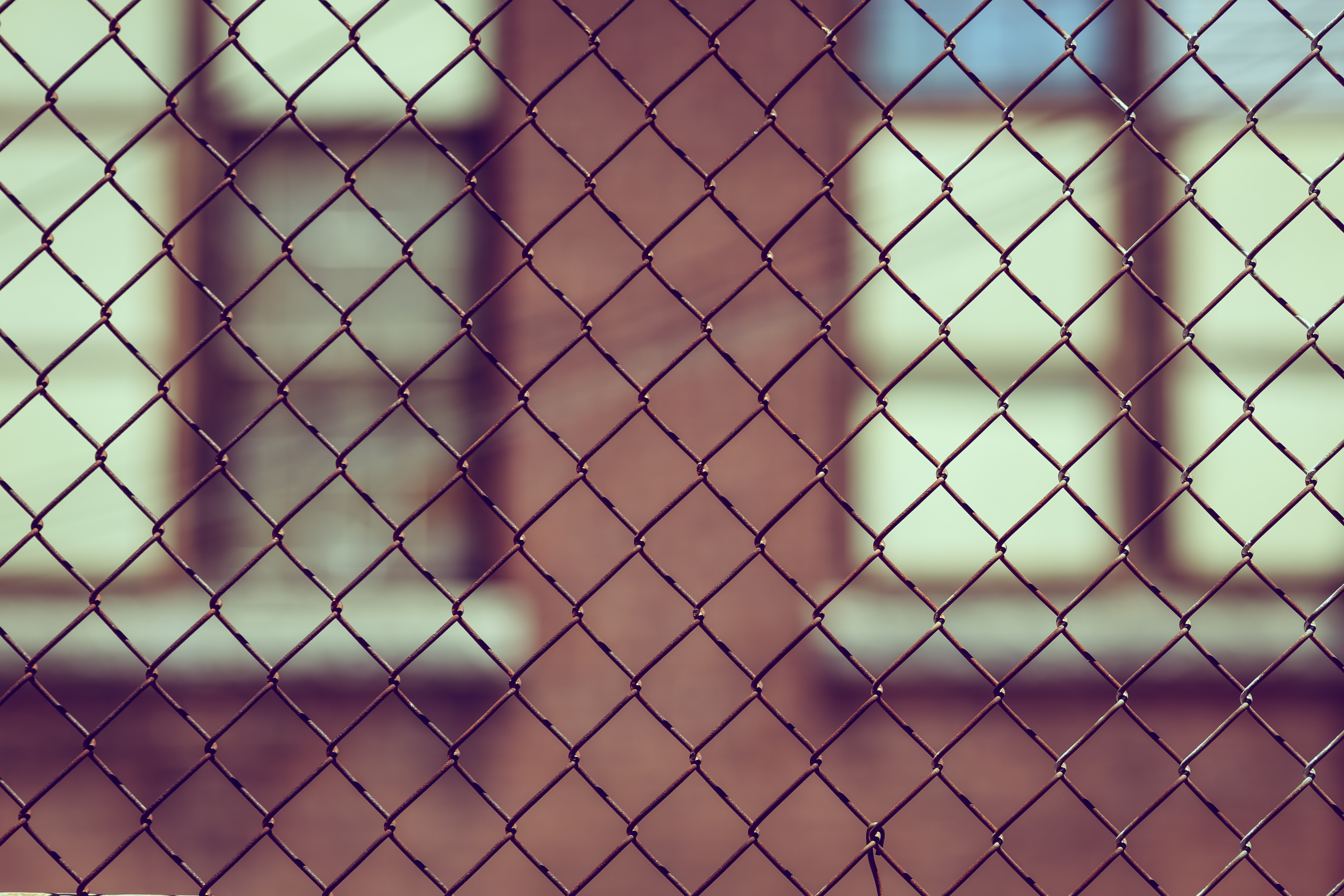 Looking at a building through a chain link fence