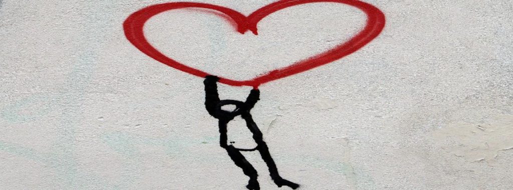 Graffiti showing a person being carried by a heart