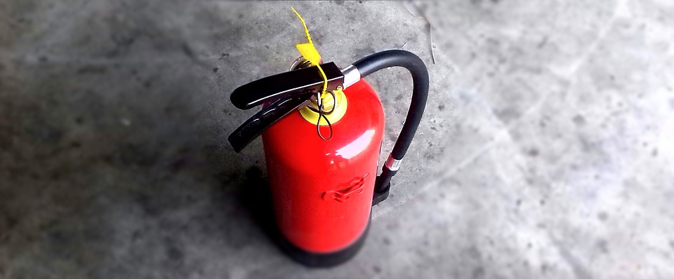 Fire extinguisher sitting on the concrete floor
