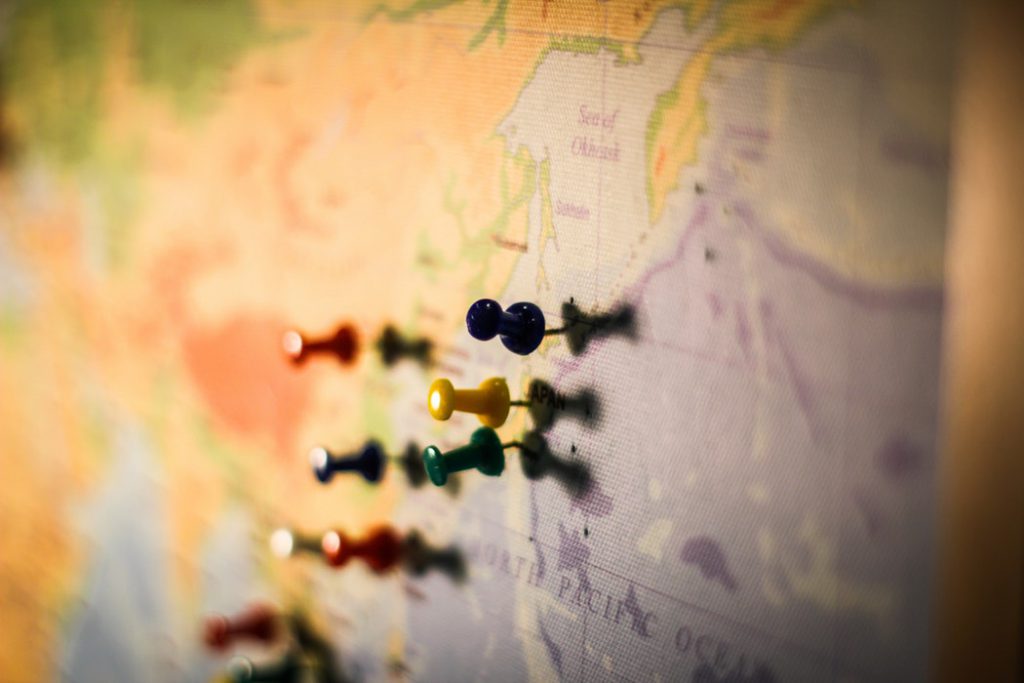 Coloured push pins on world map