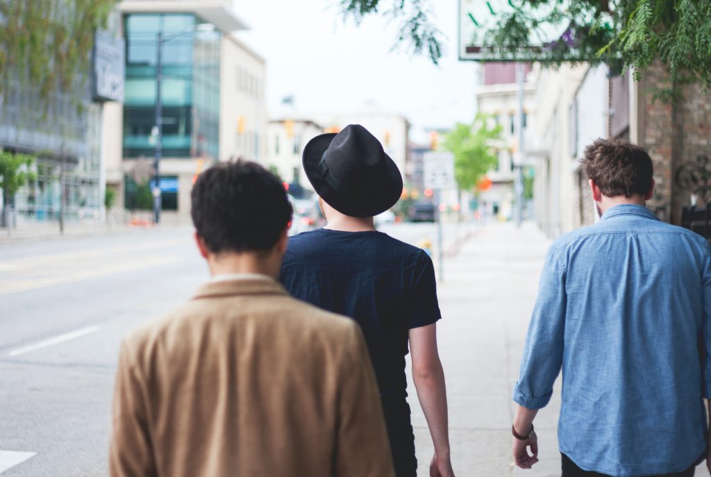 Three men walking down the street