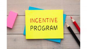 Incentive Program is written on a sticky note beside an eraser and two pencils